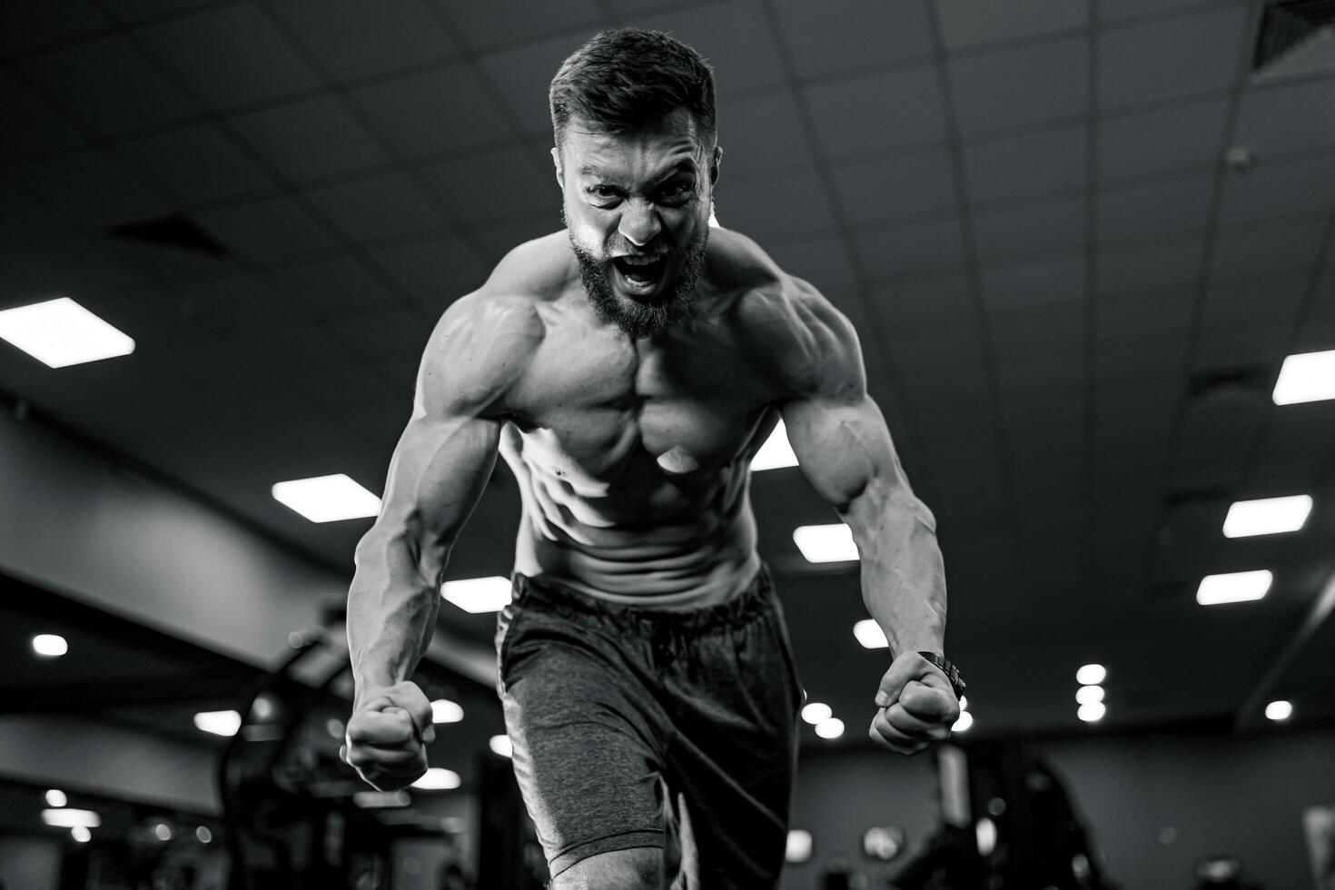 Bodybuilder with strong muscles. Hard training in gym shirtless man. photo