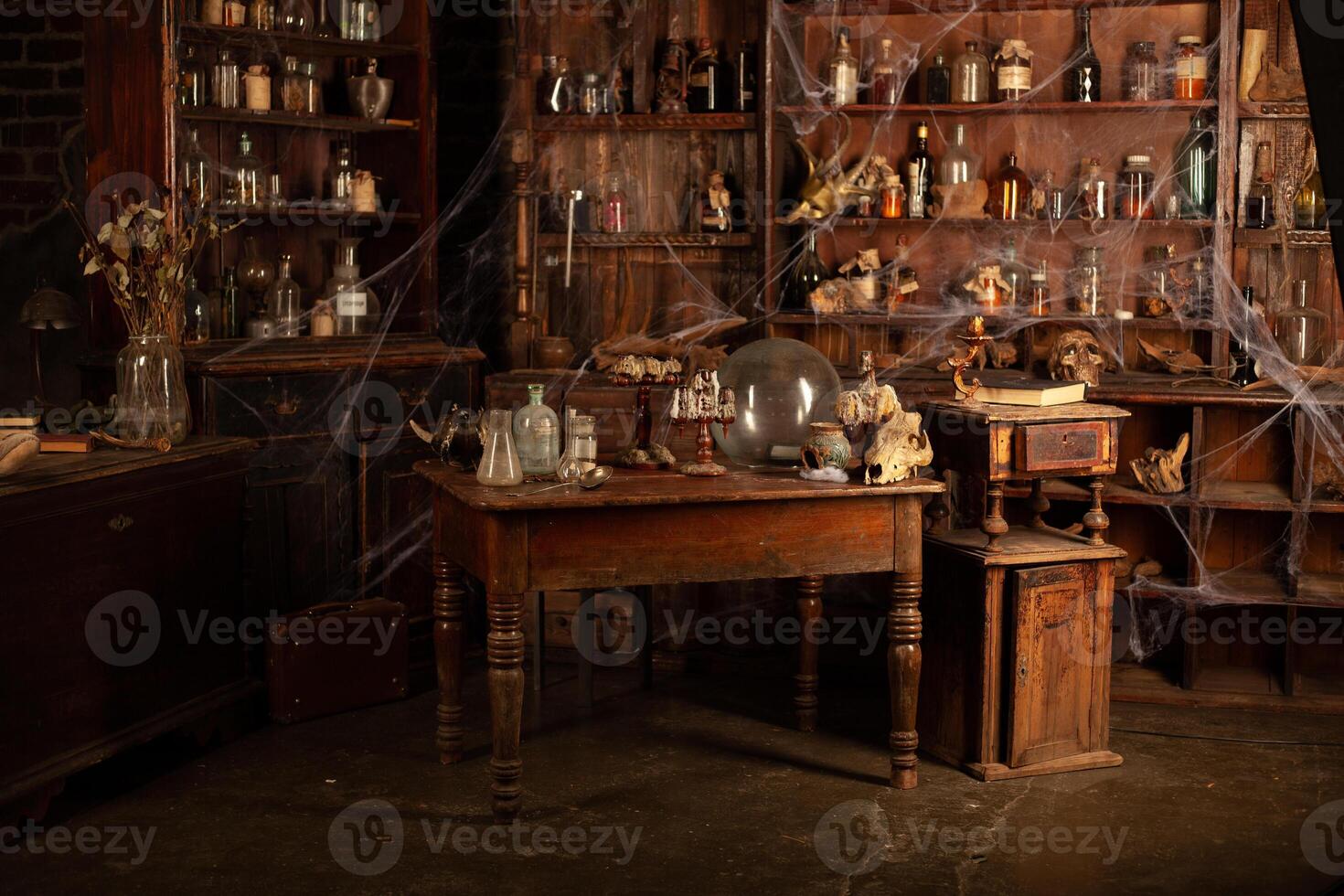Halloween background Shelves with alchemy tools Skull spiderweb bottle with poison candles photo