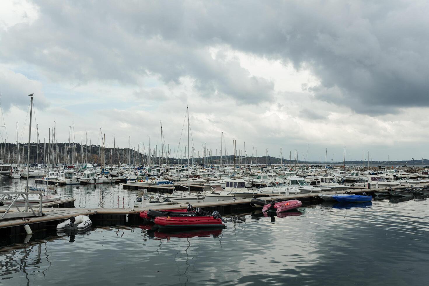 Morgat, France 29 May 2018 Panoramic outdoor view of sete marina Many small boats and yachts aligned in the port. Calm water and blue cloudy sky. photo