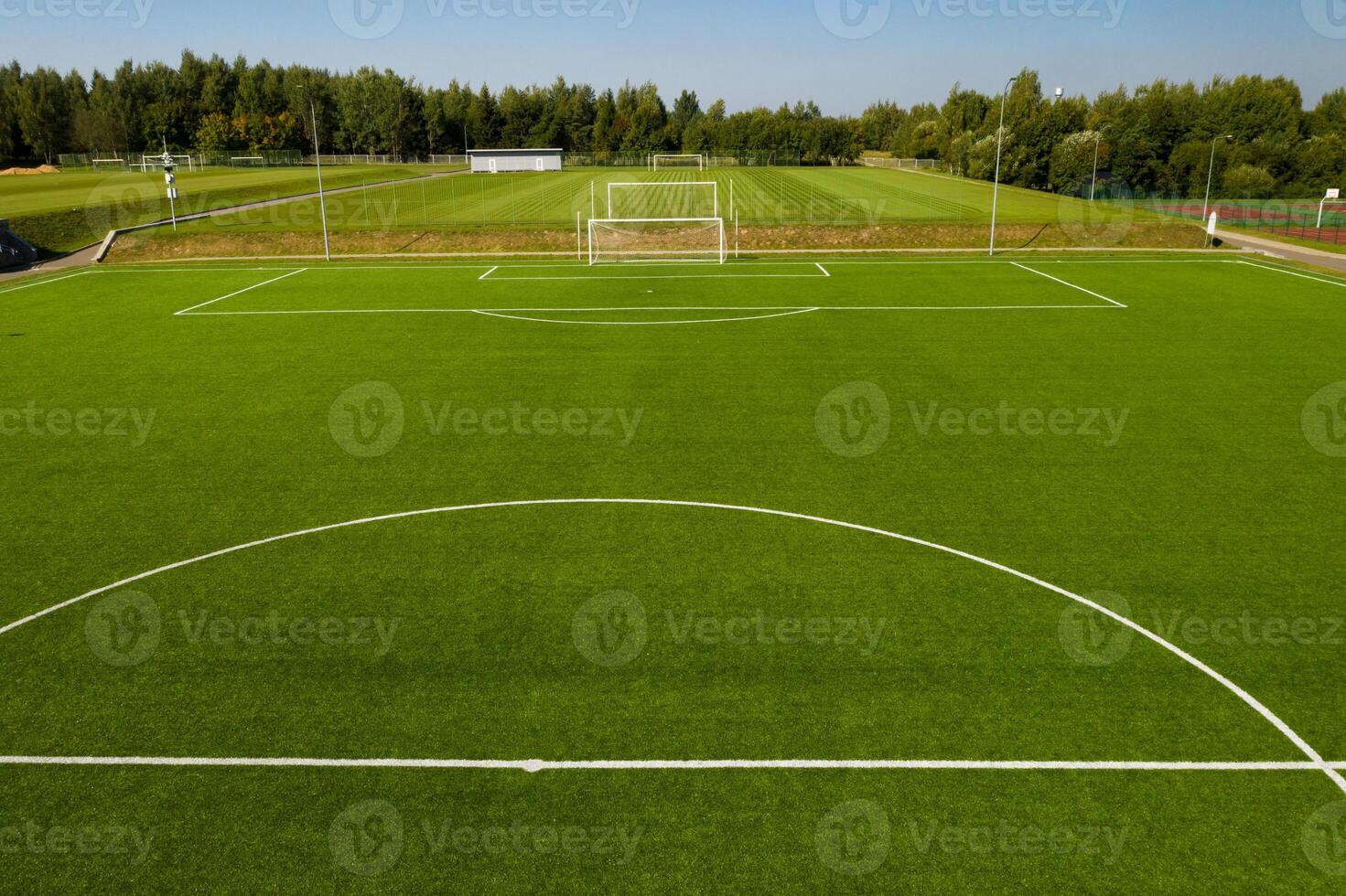 Top view of a football field with green grass outdoors in summer photo