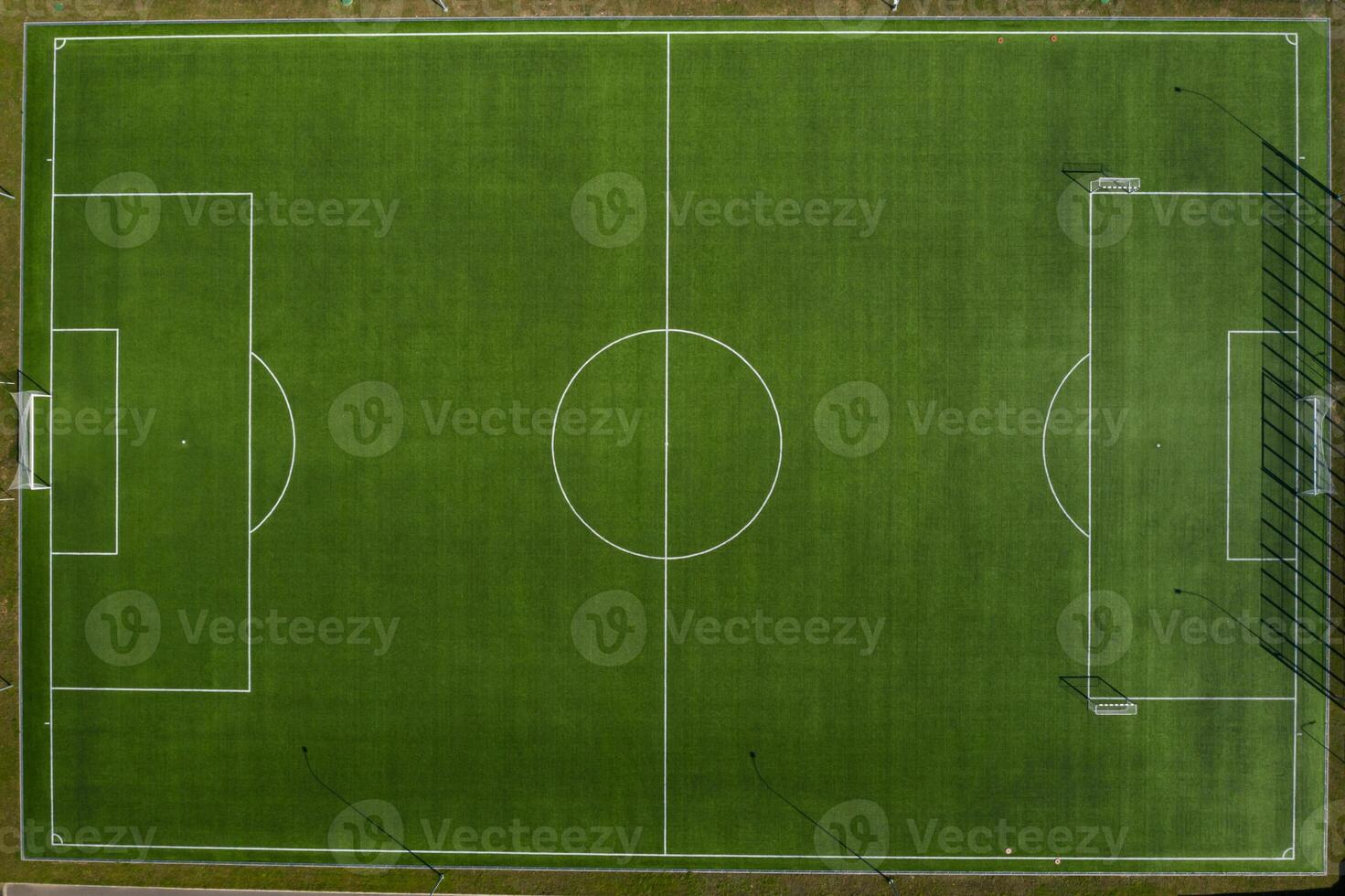 Top view of a football field with green grass outdoors in summer photo