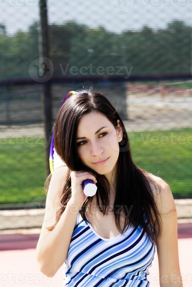 Attractive Slim Hispanic Teen Girl Holding Tennis Racket photo