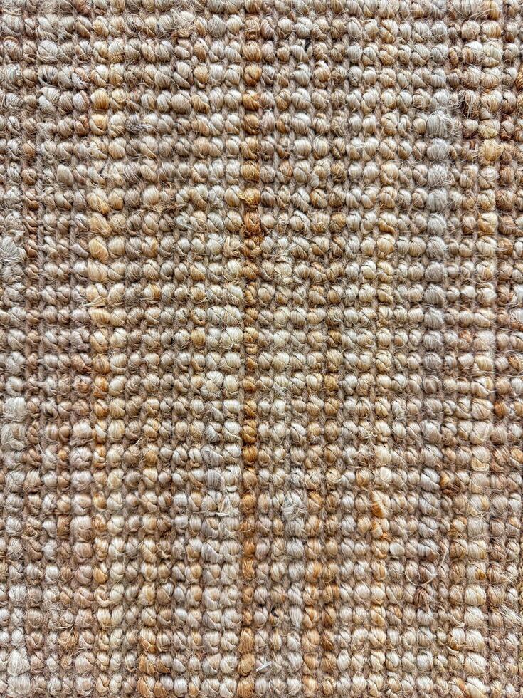 Macro shot of textured jute rug with natural beige and brown tones for interior design and home decor. photo