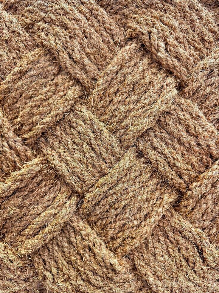 Close up of interwoven natural jute ropes creating textured pattern for rustic backgrounds and sustainable material concept. photo
