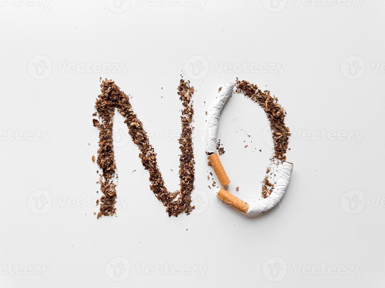 Word 'NO' created with tobacco and broken cigarette on white background for anti smoking and health concept. No tobacco day. photo