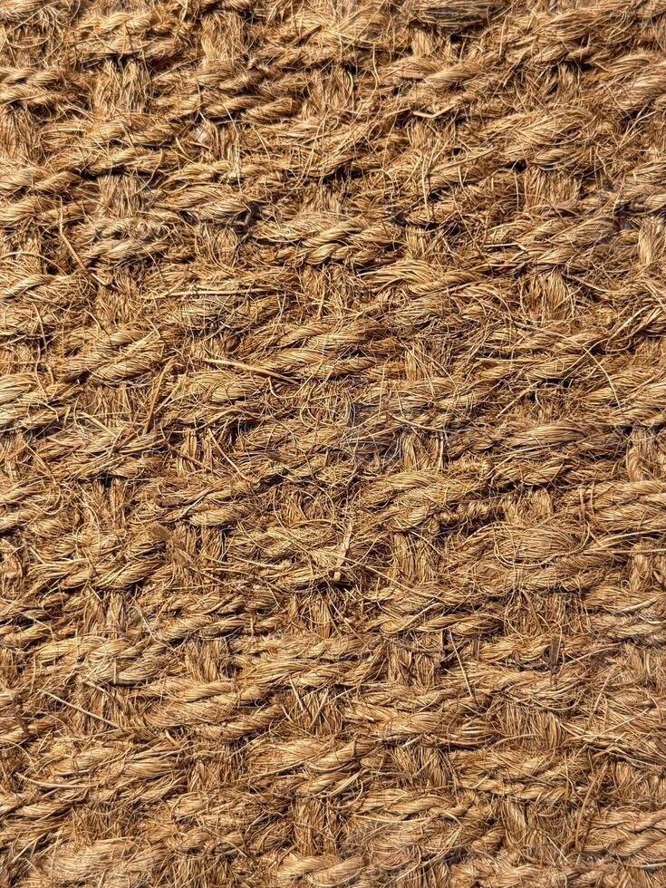 Close up of interwoven natural jute ropes creating textured pattern for rustic backgrounds and sustainable material concept. photo