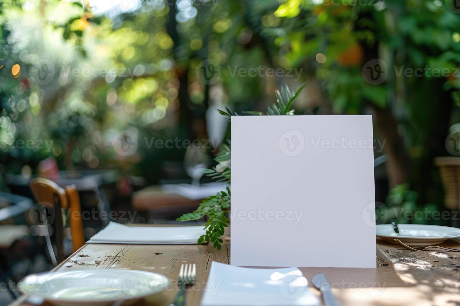Blank menu or invite standing on wooden table in outdoor garden restaurant setting with natural green background. For food and beverage marketing or design with place for text. Ai photo