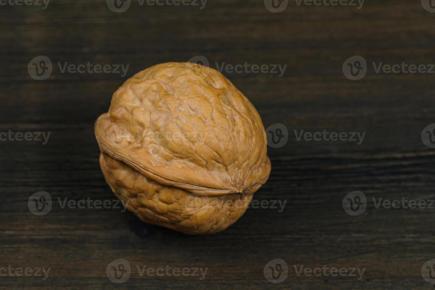Single walnut on a dark brown table. photo