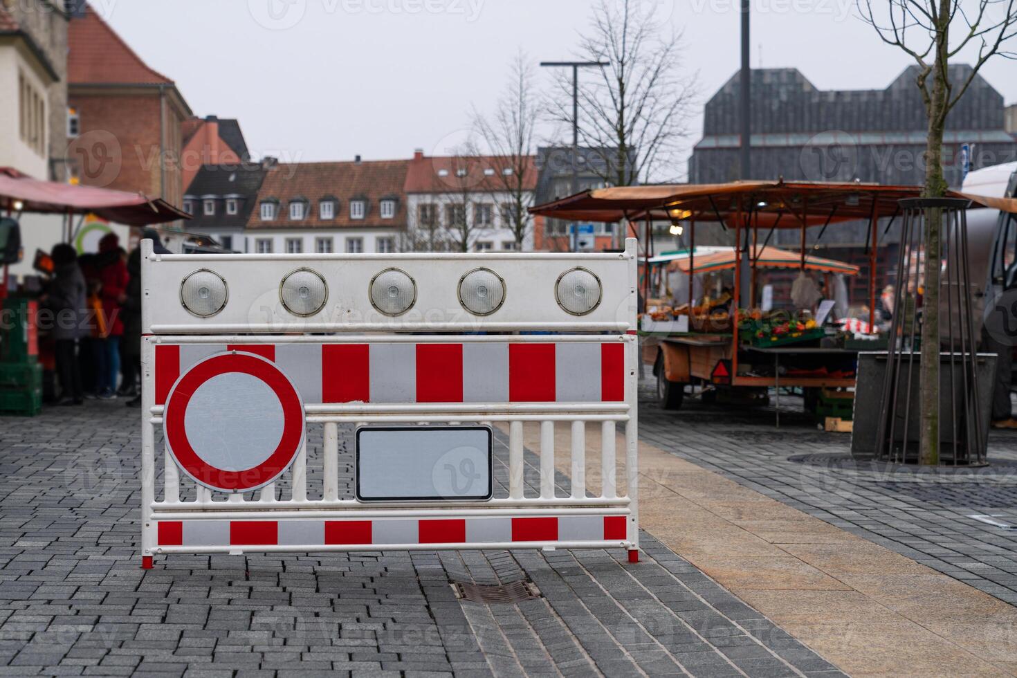 Plastic red and white barrier with a stop signal fume resurrecting entry to the peasant market. photo