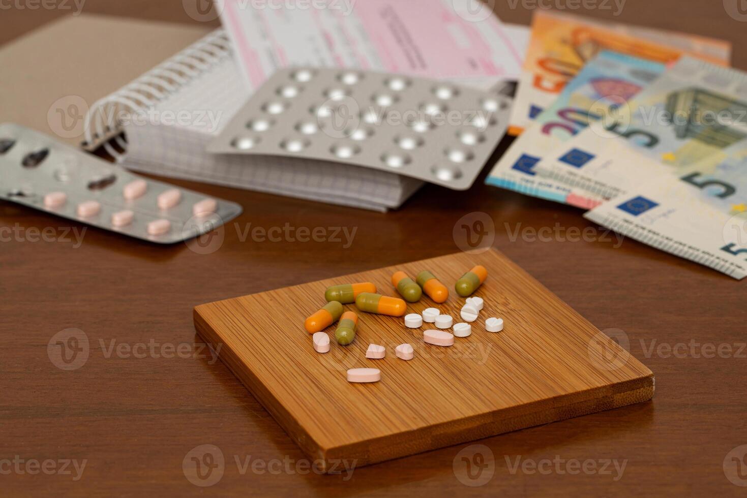 Medical tablets and pills close-up on a wooden stand. Close up. photo