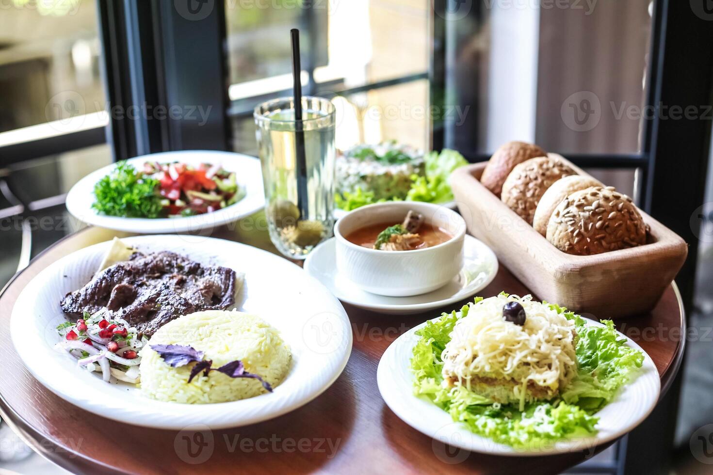 Wooden Table With Plates of Food photo