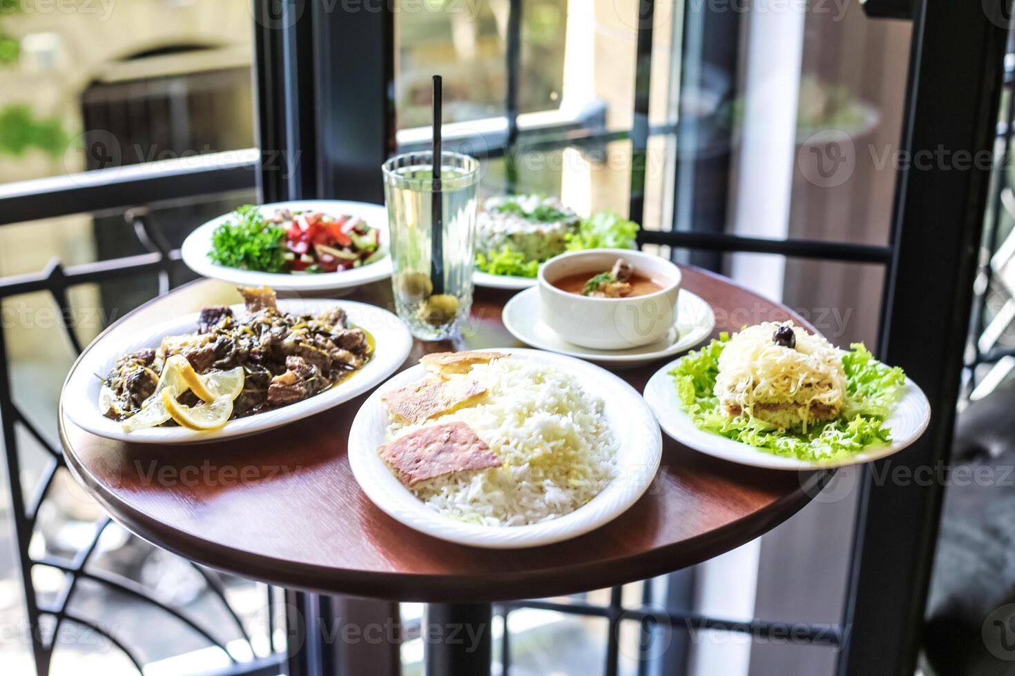 Wooden Table With Assorted Plates of Food photo
