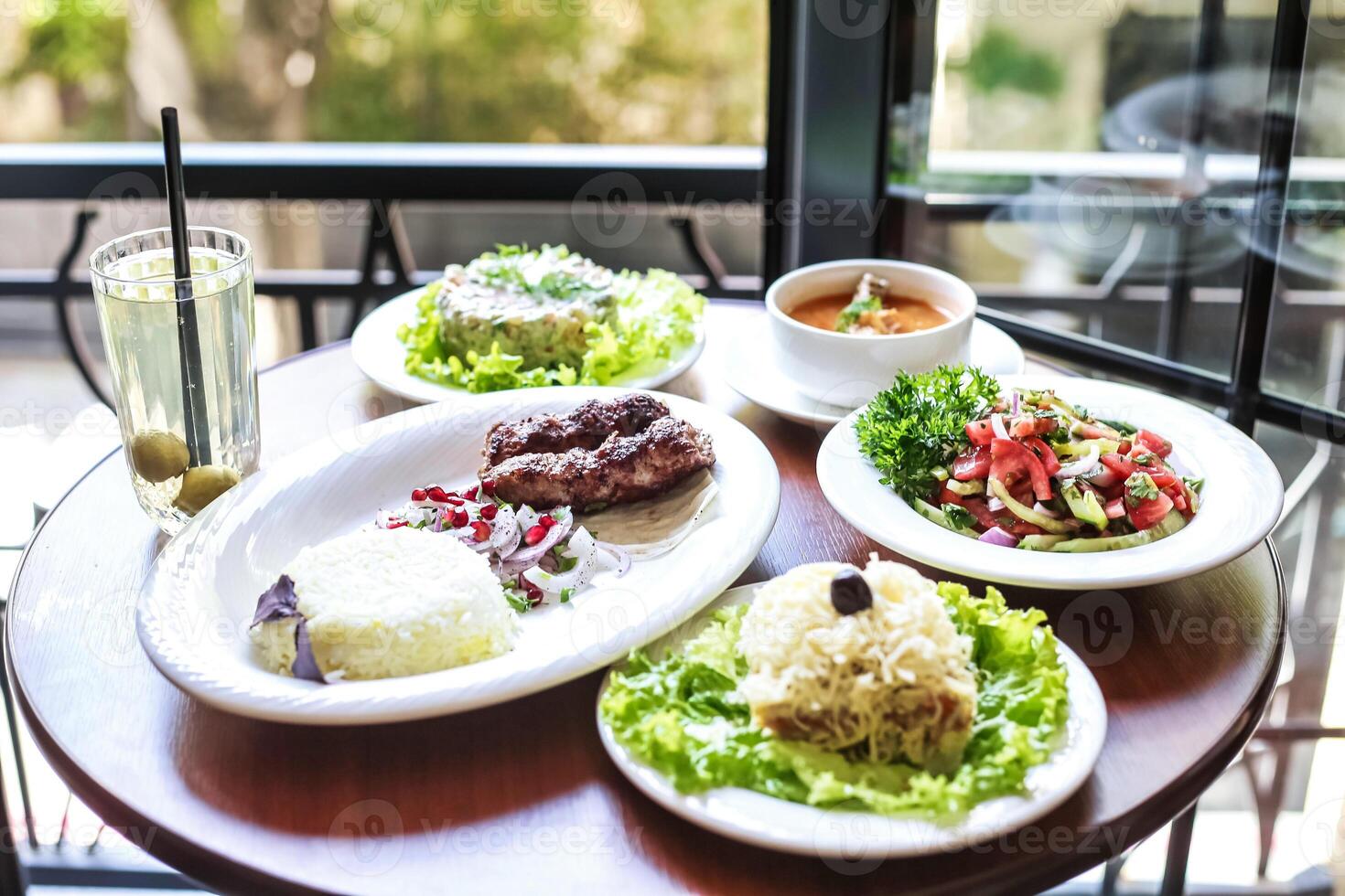 Wooden Table Set With Delicious Plates of Food photo