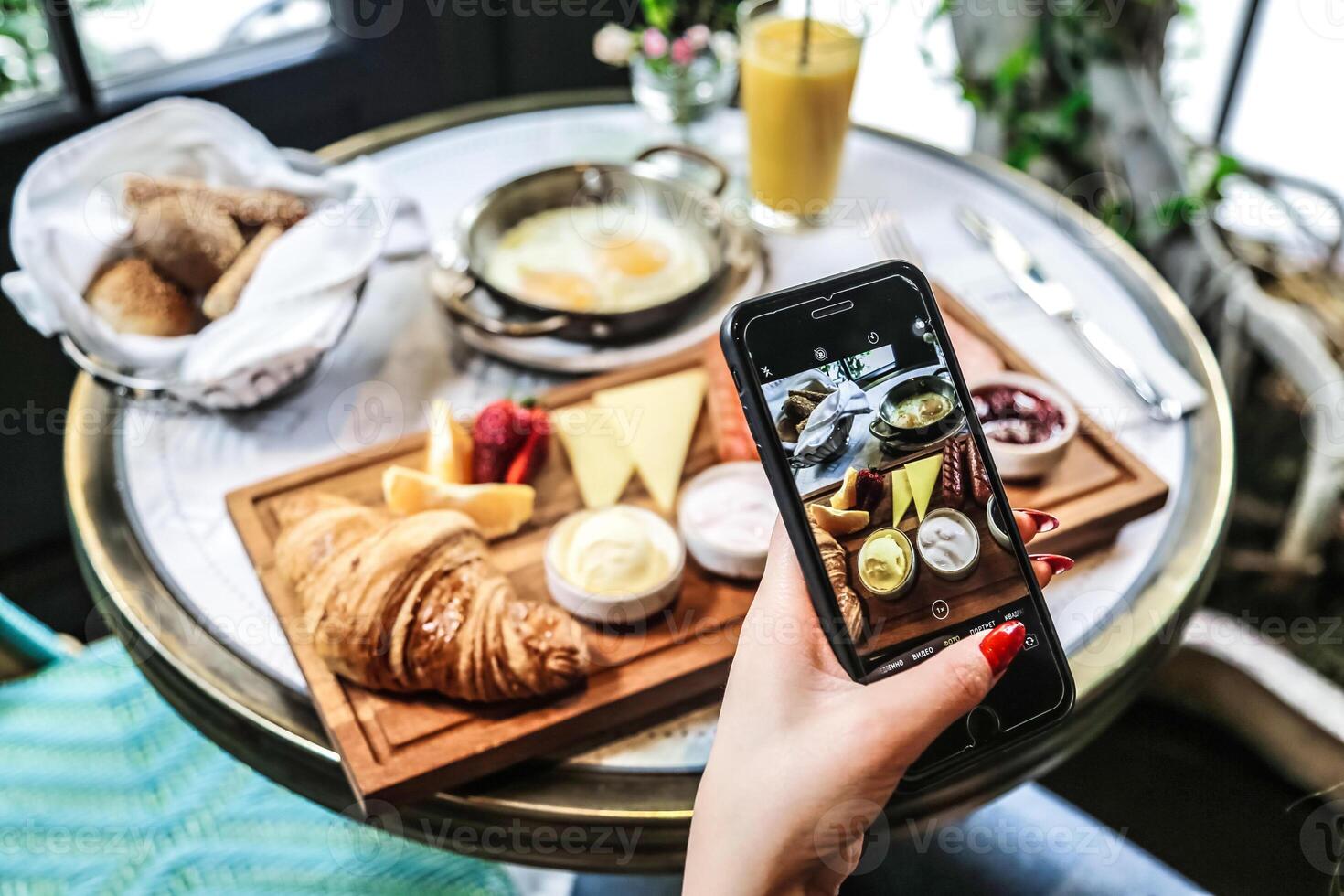 Person Taking Picture of Food on Table photo