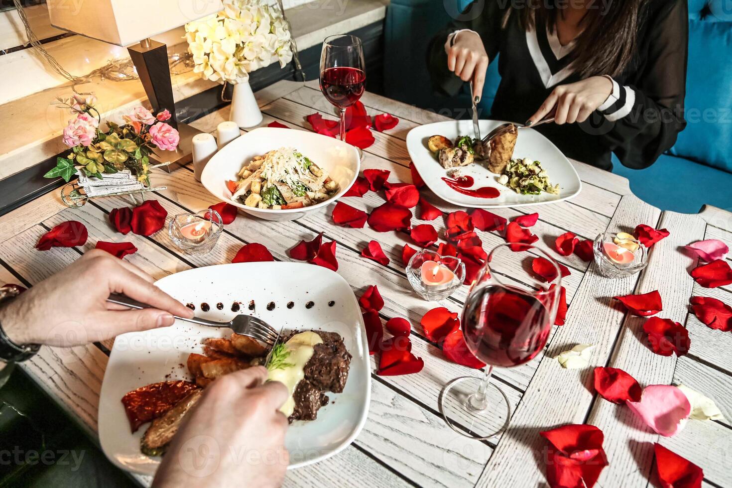 Couple Enjoying a Meal Together at a Table With Plates of Food photo