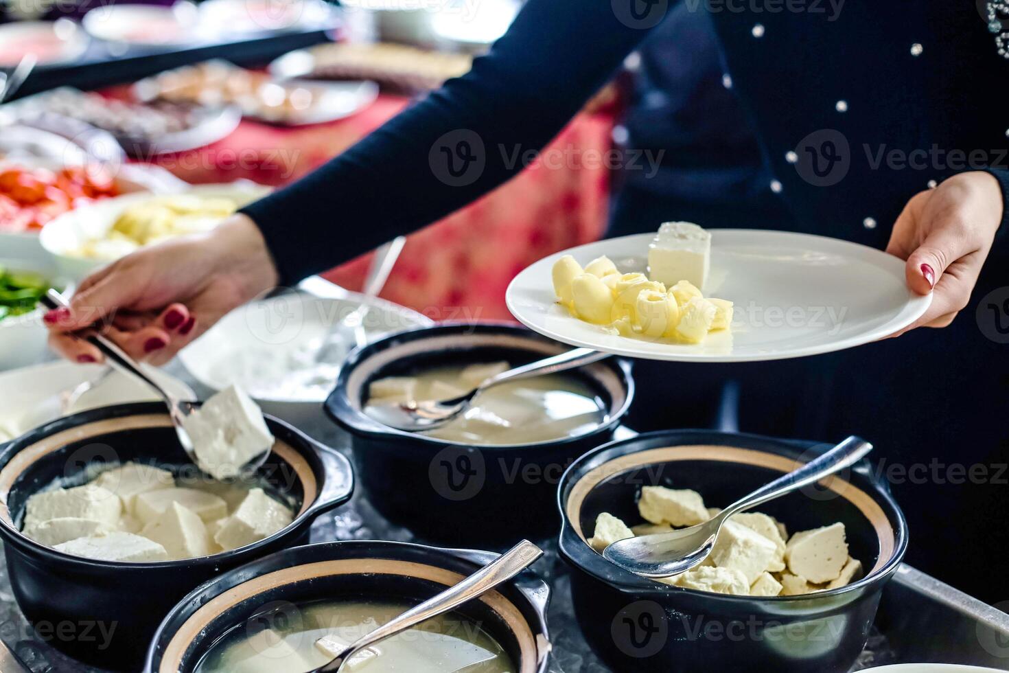 Woman Serving Food From a Buffet Table at a Party photo