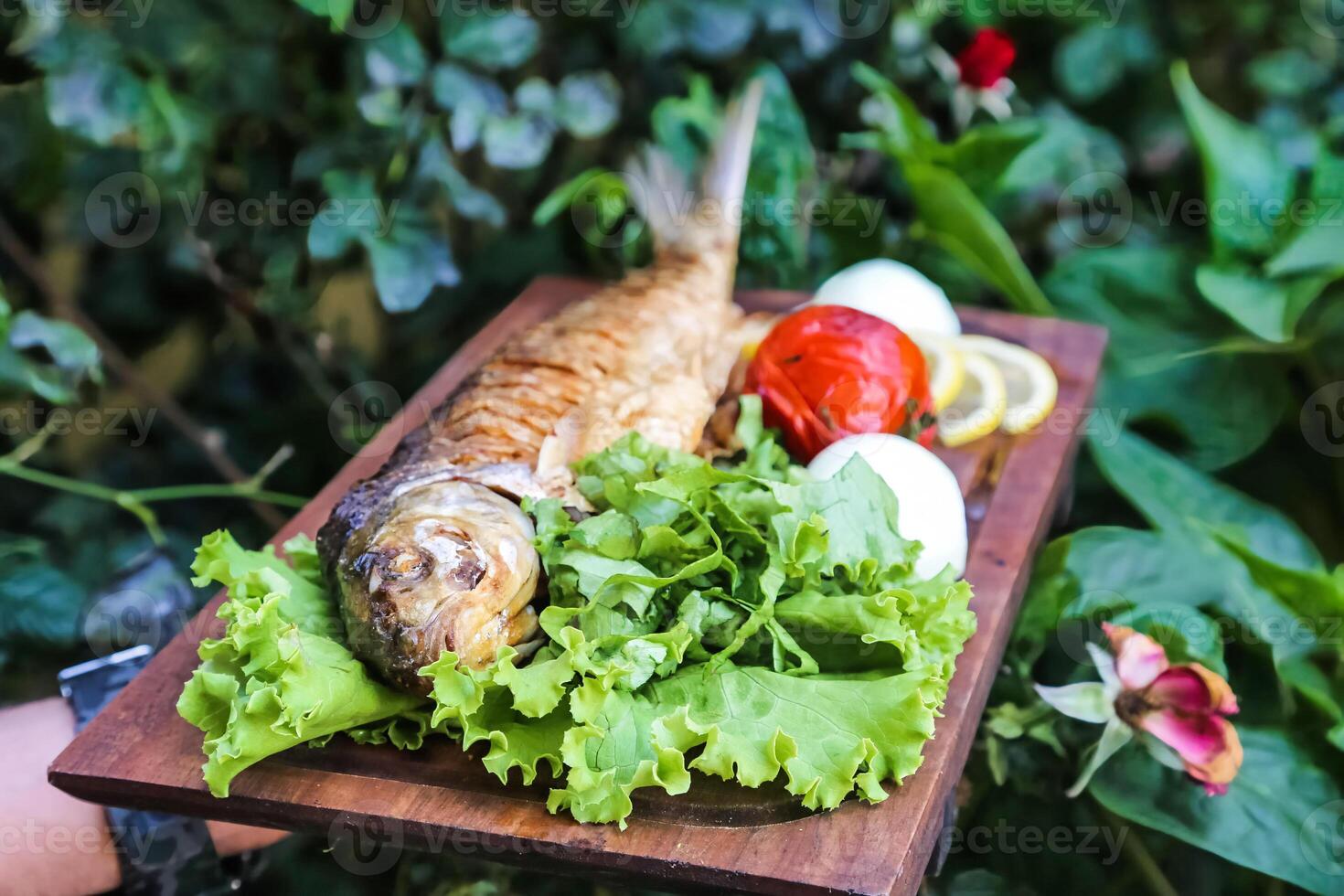 Wooden Cutting Board With Lettuce and Fish photo