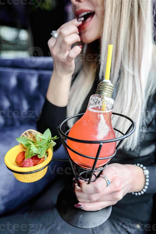 Woman Sitting at Table With Drink photo