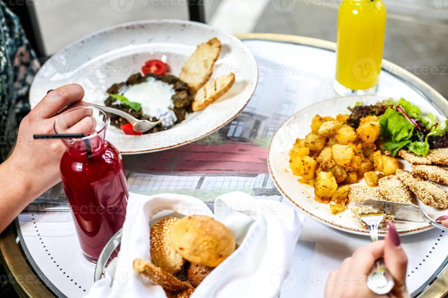 Table Adorned With Plates of Food and Drinks for a Delightful Meal photo