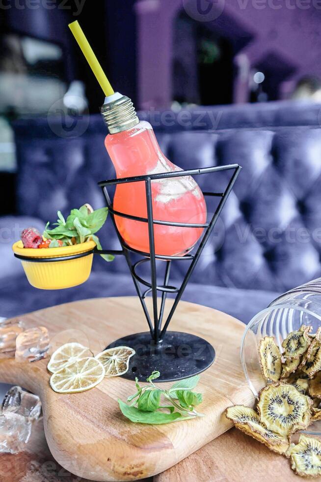Wooden Table With Fruit Bowl and Light Bulb photo