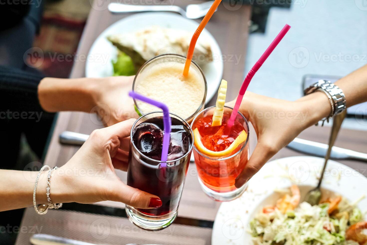 Group of People Holding Glasses of Drinks at Social Gathering photo