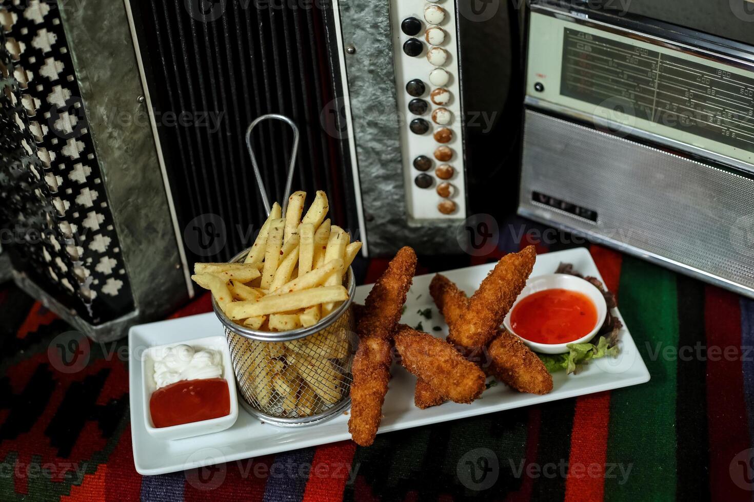 Plate of Crispy French Fries and Cup of Ketchup photo
