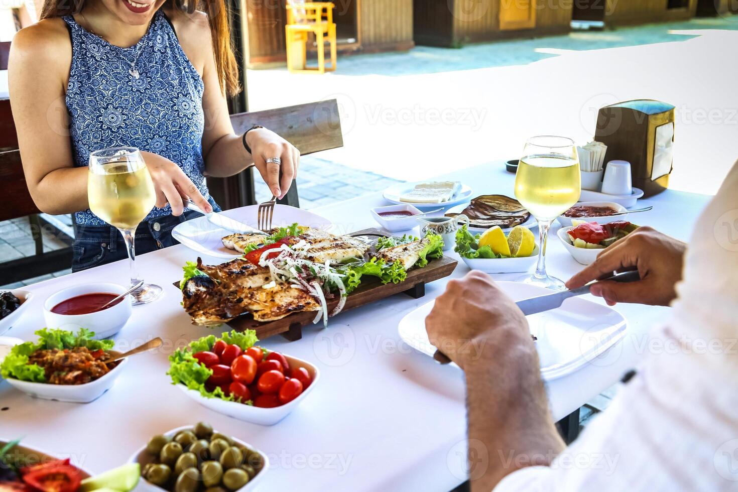 Man and Woman Enjoying a Meal at a Table photo