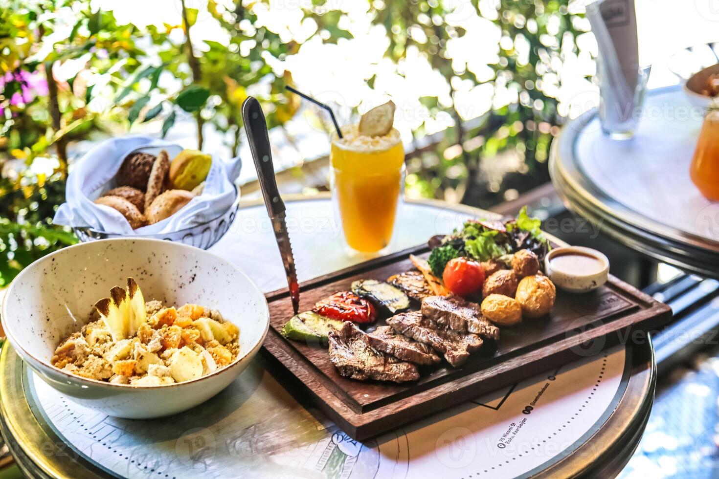 Table With Assorted Plates of Food and Drinks photo
