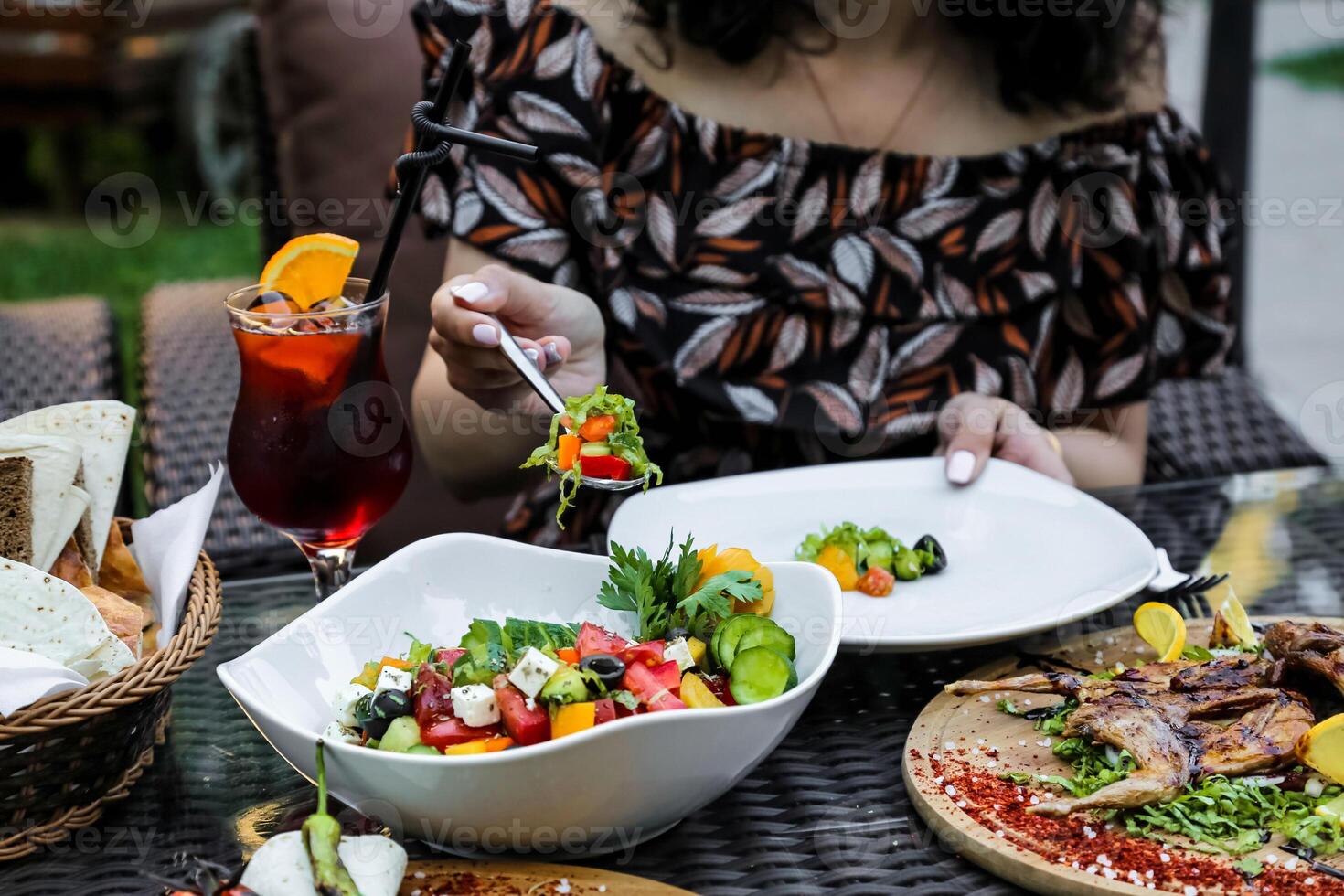Woman Sitting at Table With Plates of Food photo