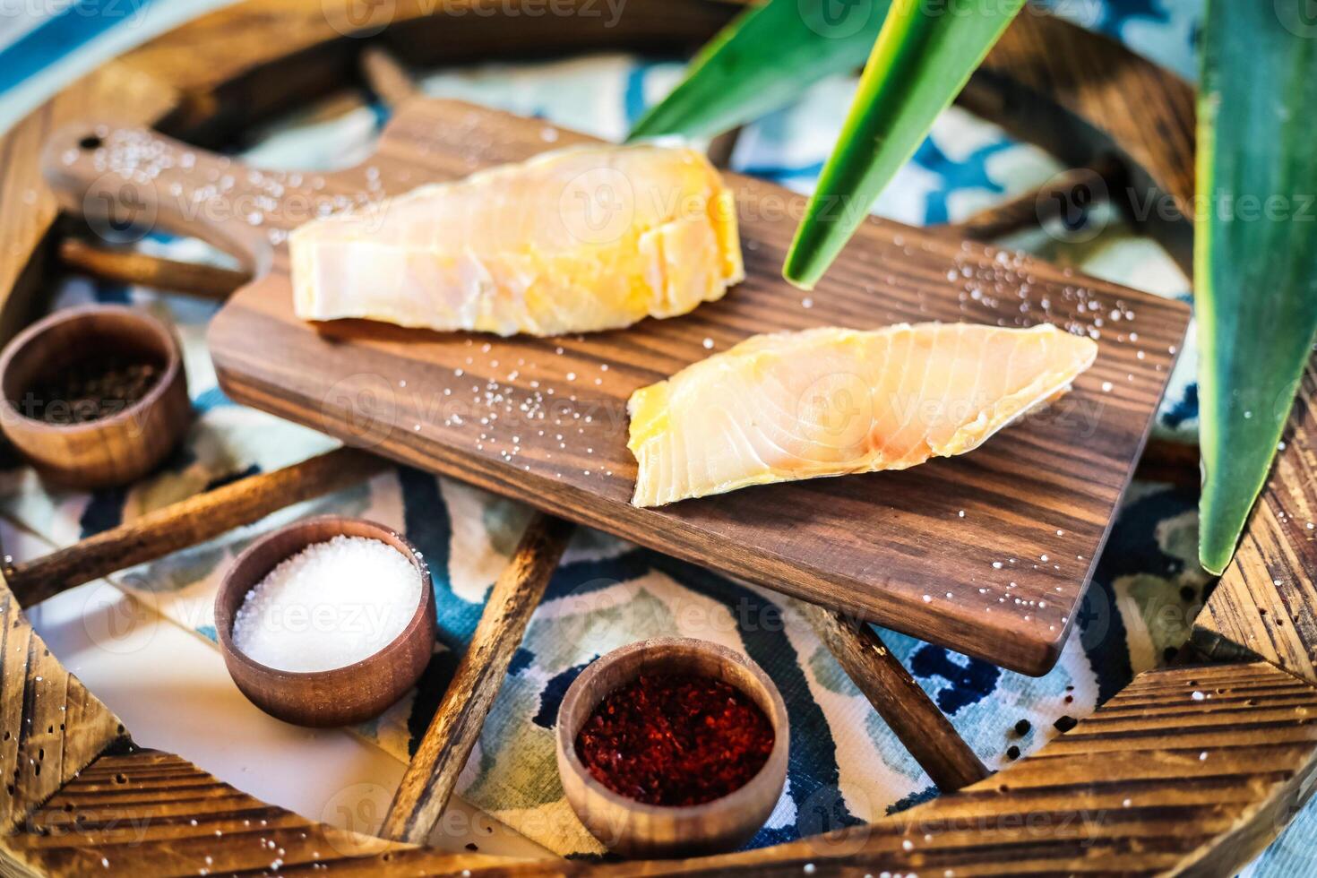 Wooden Tray Topped With Slices of Fish photo