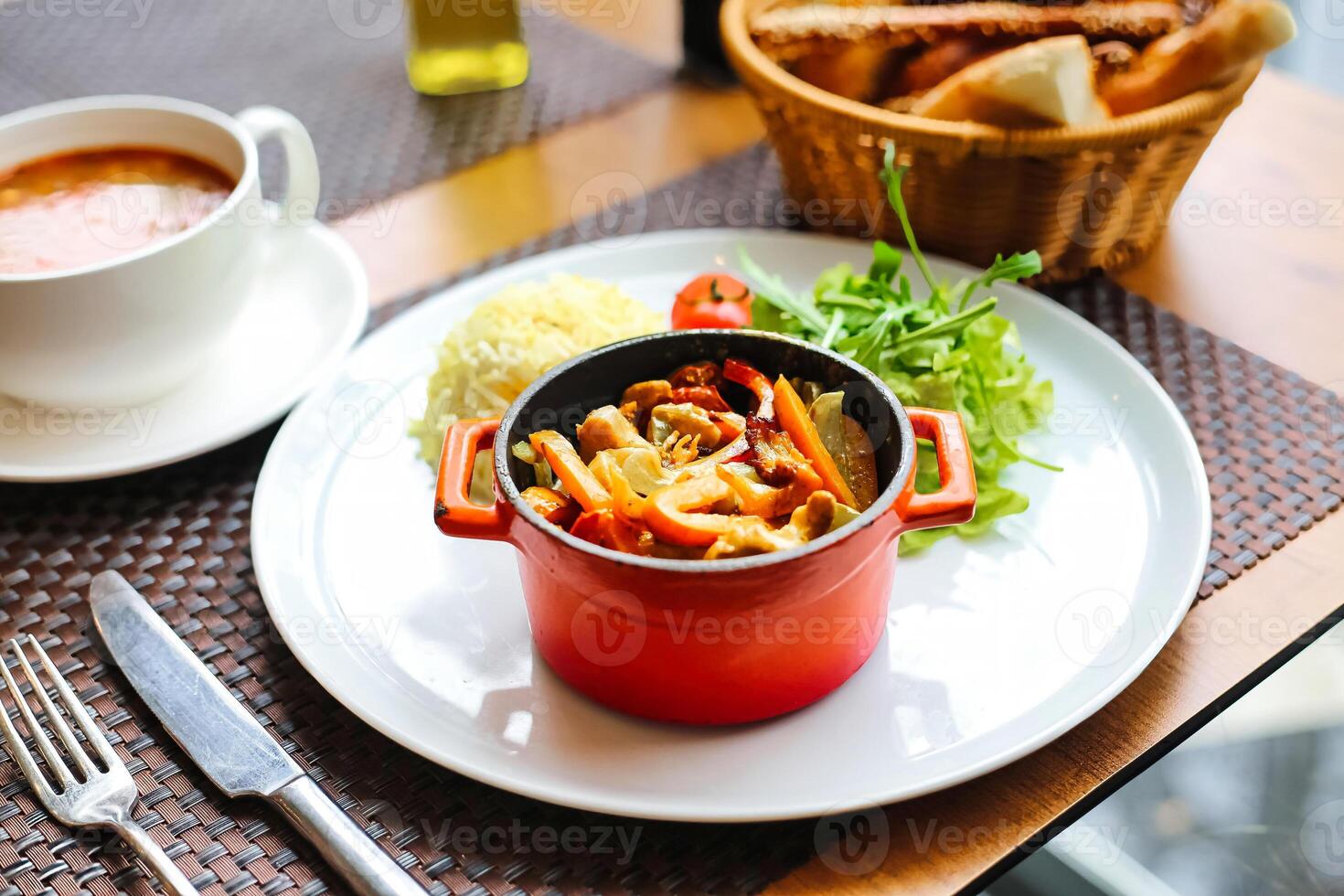 Delicious Plate of Food With a Bowl of Soup on a Table photo