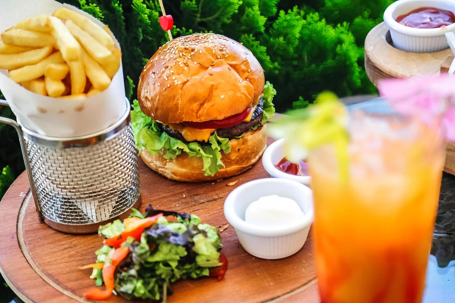 Delicious Hamburger and Fries on Wooden Table photo
