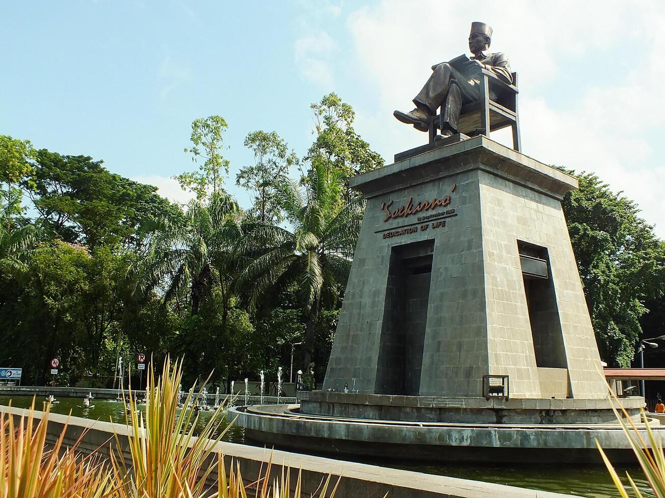 Surakarta, Central Java, Indonesia April 11, 2024. The statue of Mr Soekarno sitting while reading a book, statue of the first president of The Republik Indonesia at Manahan Stadium. photo