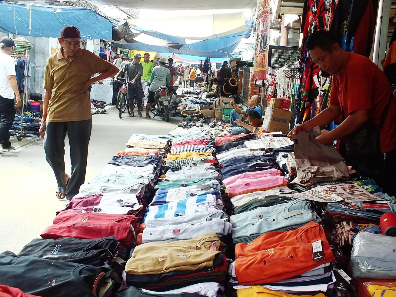 Sukoharjo, Central Java, Indonesia, April 15, 2024 Busy people, seller buyer at Gawok traditional market, located near Surakarta City. A lot of farmer tools was selling on this market. photo