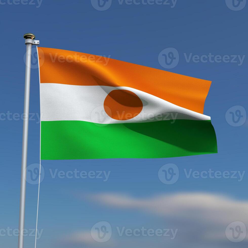 Niger Flag is waving in front of a blue sky with blurred clouds in the background photo