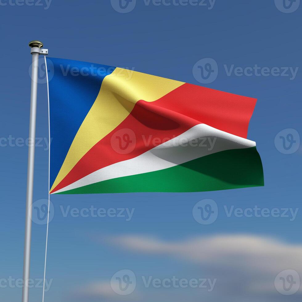 Seychelles Flag is waving in front of a blue sky with blurred clouds in the background photo