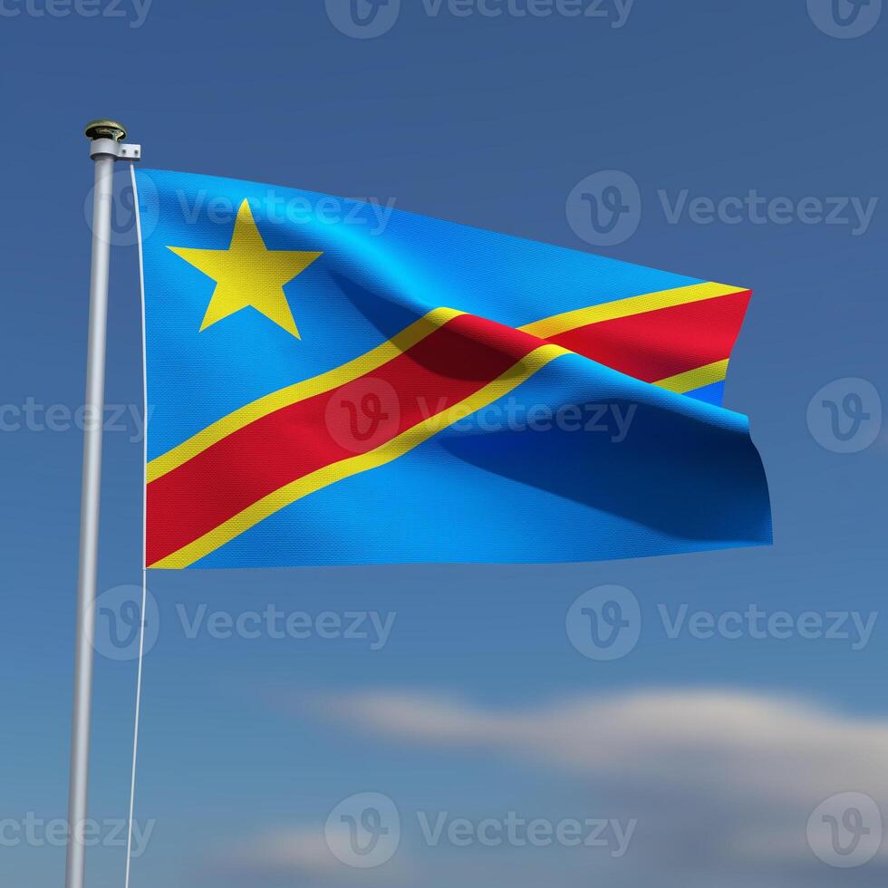 Congo Flag is waving in front of a blue sky with blurred clouds in the background photo