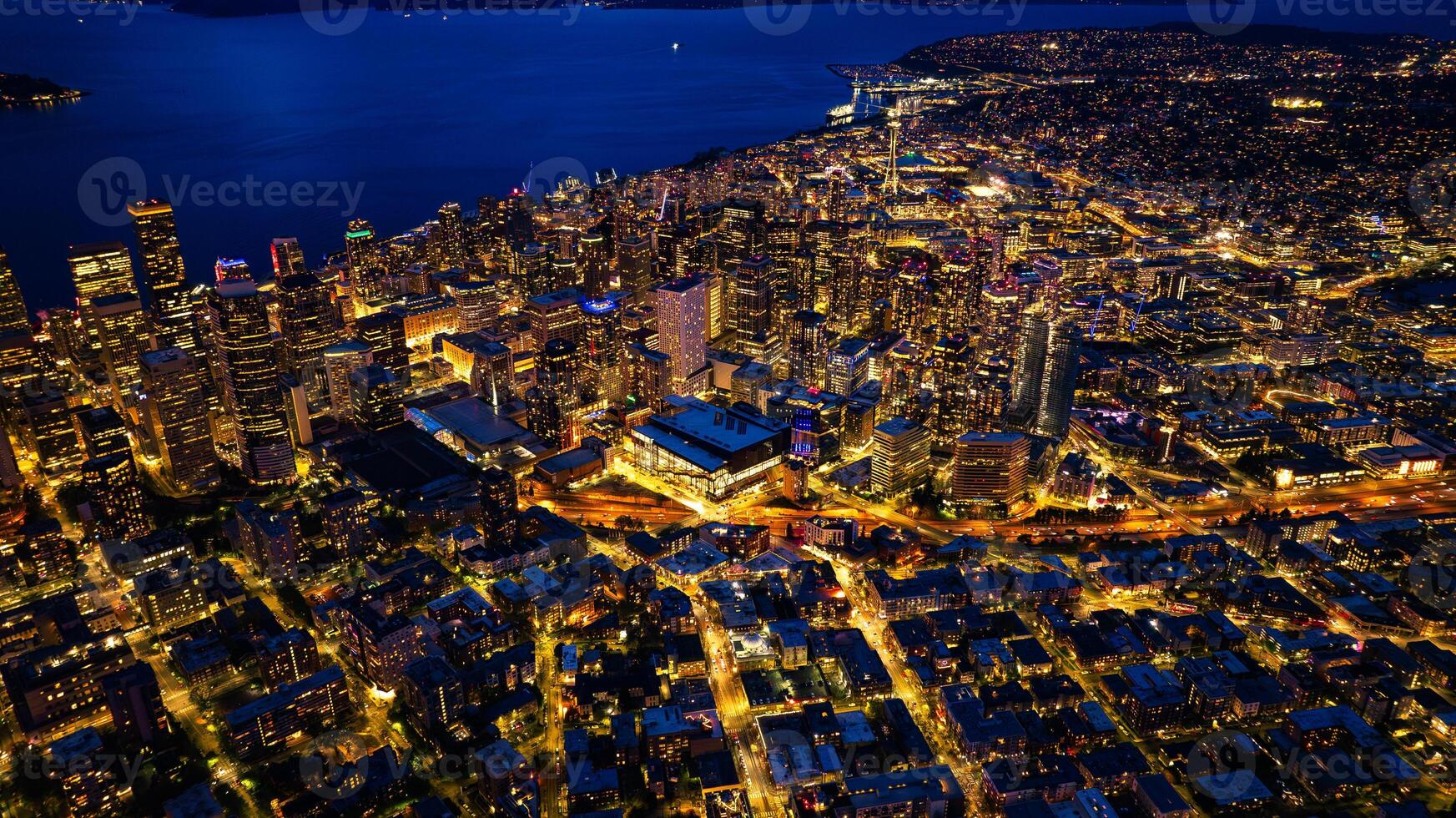 Splendid scenery of the vibrant downtown of Seattle, Washington, the USA. Blue waterscape and evening night at backdrop. photo