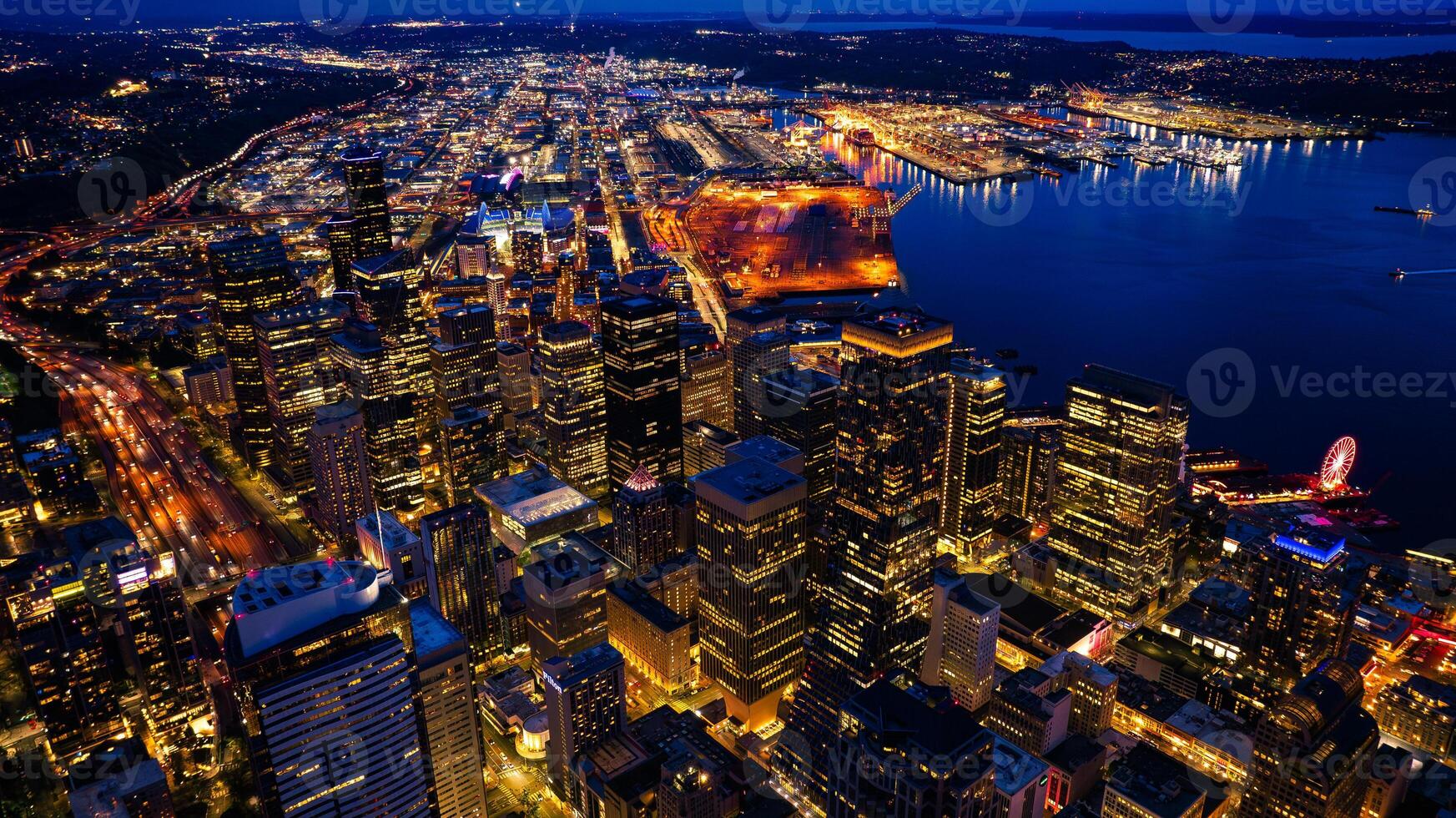 Splendid scenery of the vibrant downtown of Seattle, Washington, the USA. Blue waterscape and evening night at backdrop. photo