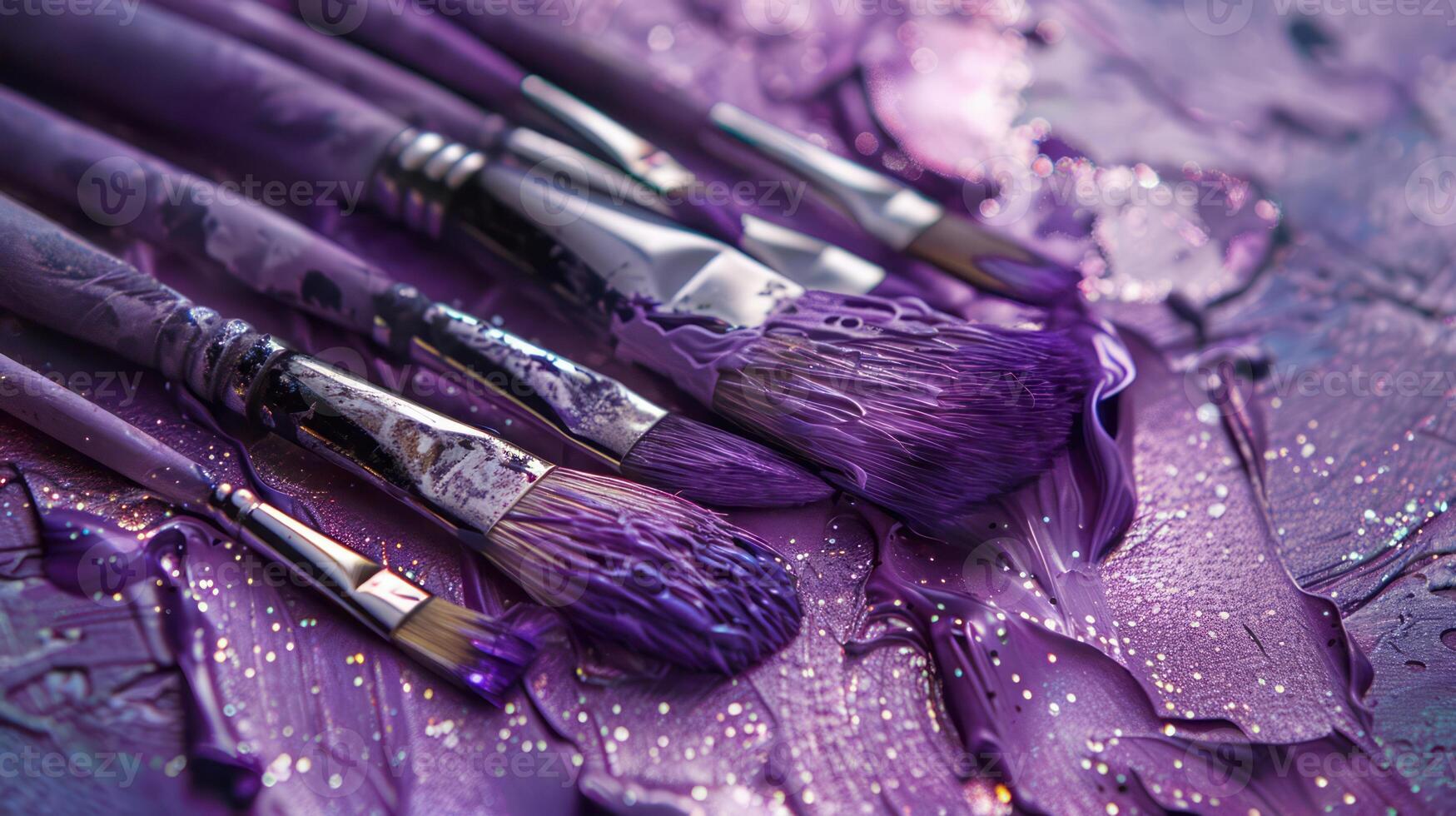 A collection of brushes set on a palette with shimmering violet paint photo