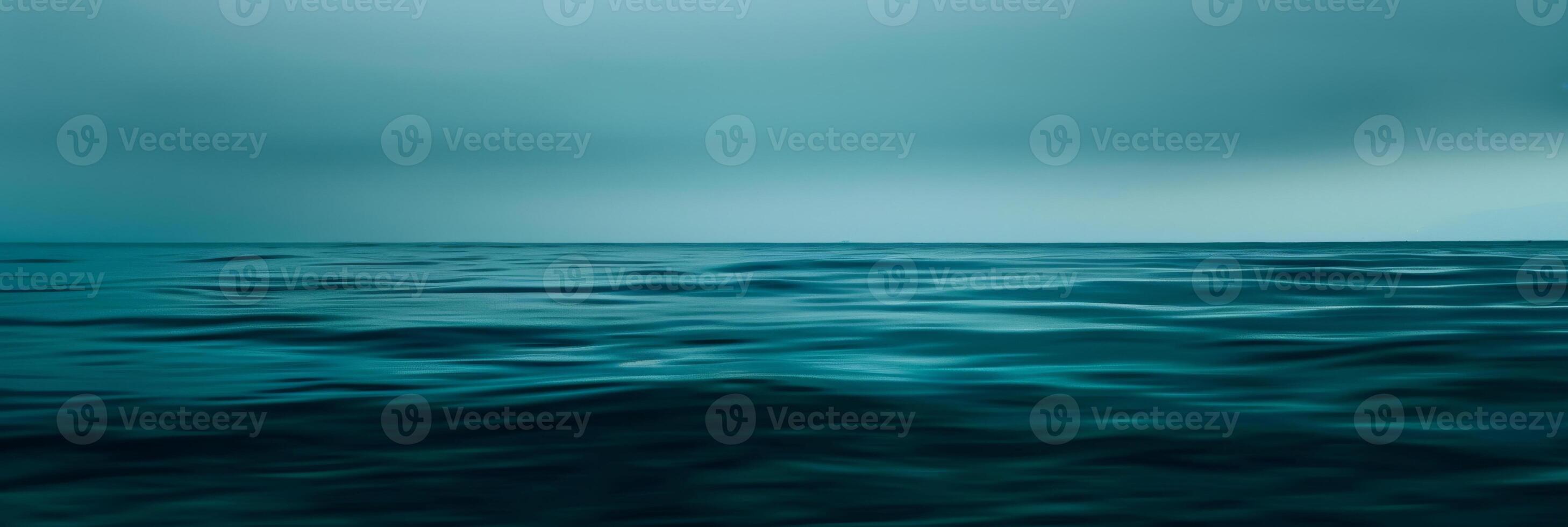 The ocean is calm and blue, with no visible waves photo