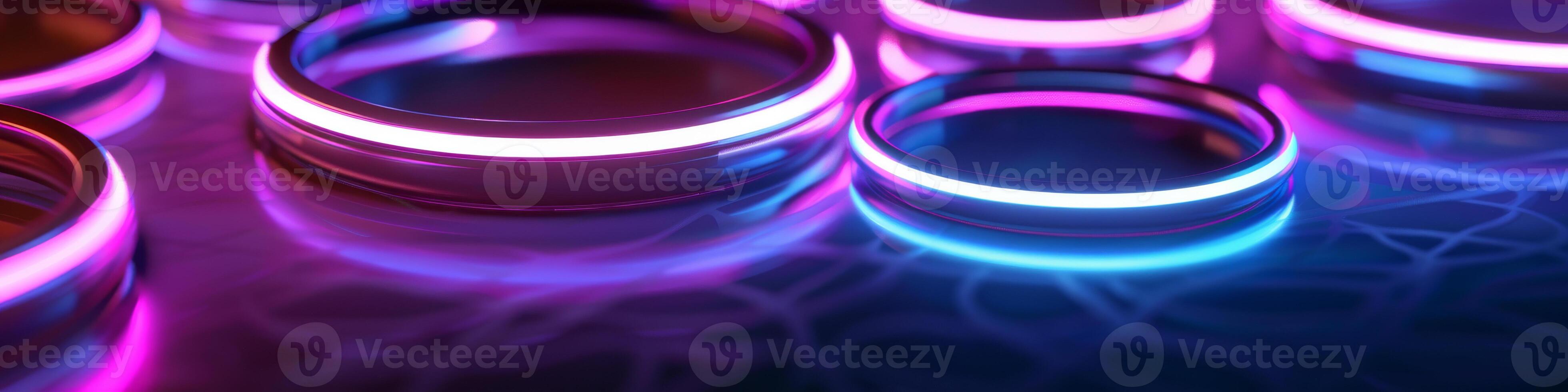 Glowing Neon Purple and Blue Rings on Reflective Surface photo