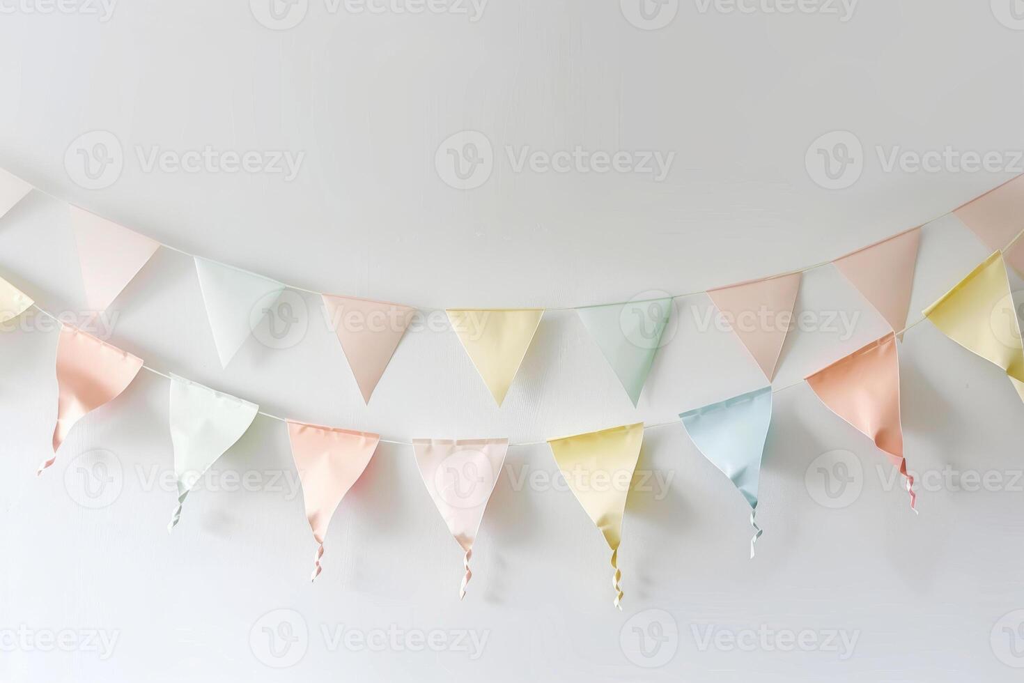 A colorful banner with flags hanging from a white wall photo