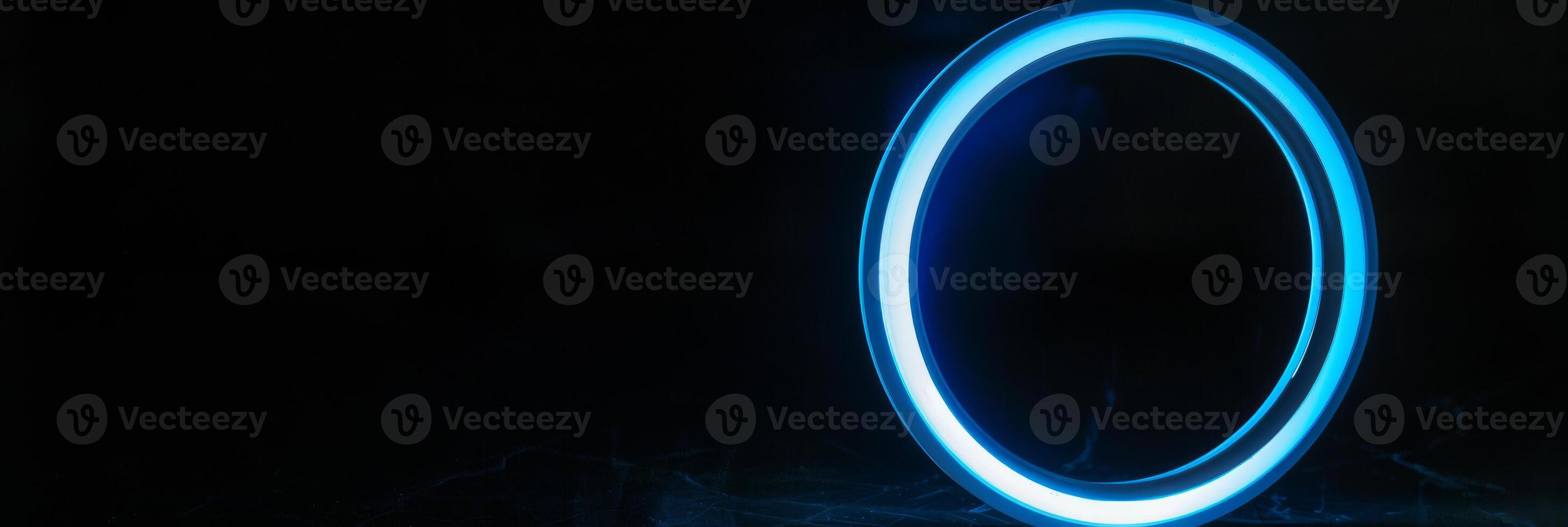 Bright Blue Illuminated Ring Against Black Background photo