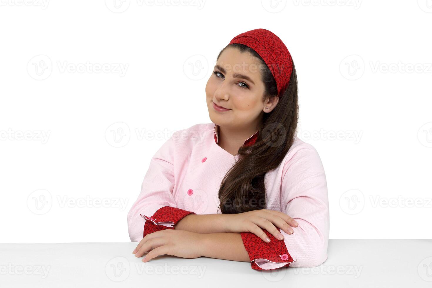 young and friendly chef posing on white background photo