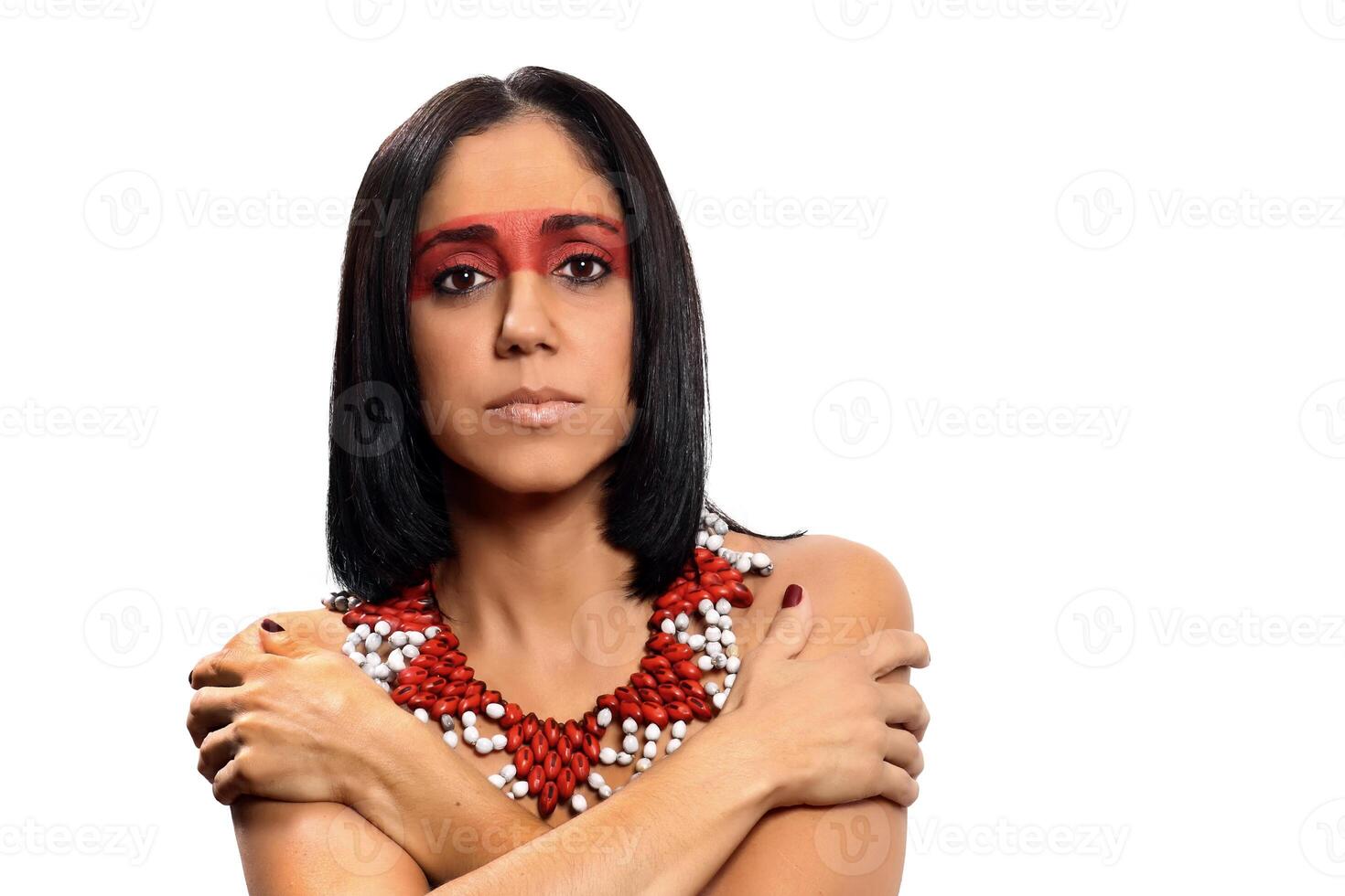 smiling brunette model in Brazilian Indian costume and makeup holding a tapioca, a typical Brazilian snack photo
