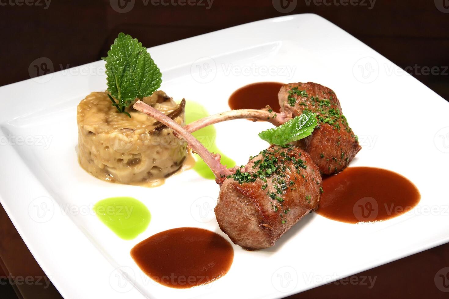 grilled lamb with dried mushroom risotto and rust sauce photo