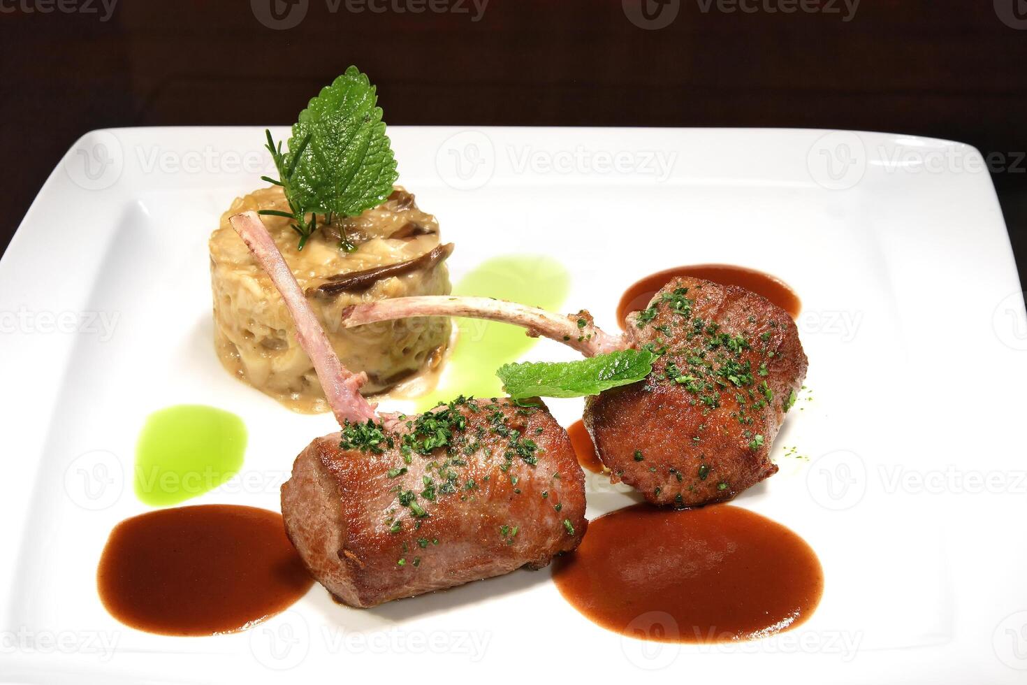 grilled lamb with dried mushroom risotto and rust sauce photo