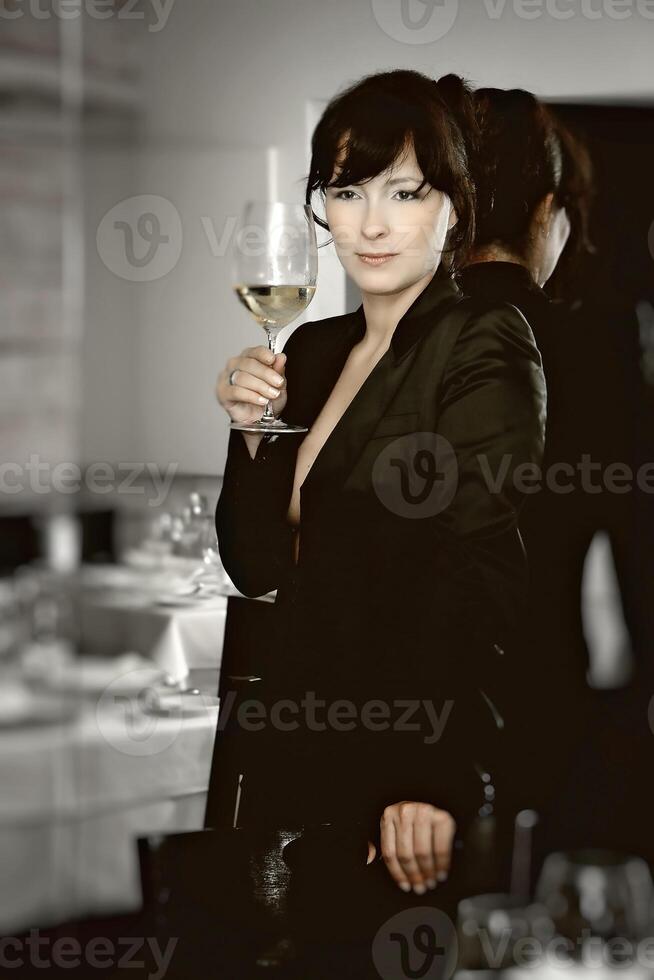 beautiful professional sommelier tasting and evaluating wines in restaurant photo