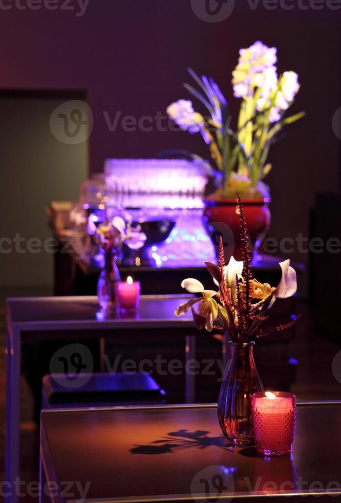 sophisticated party decoration with candles, flowers, tables and specialized lighting photo